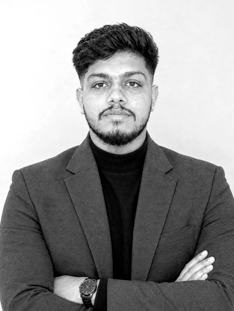 Harish Sharma in a grey blazer with arms folded