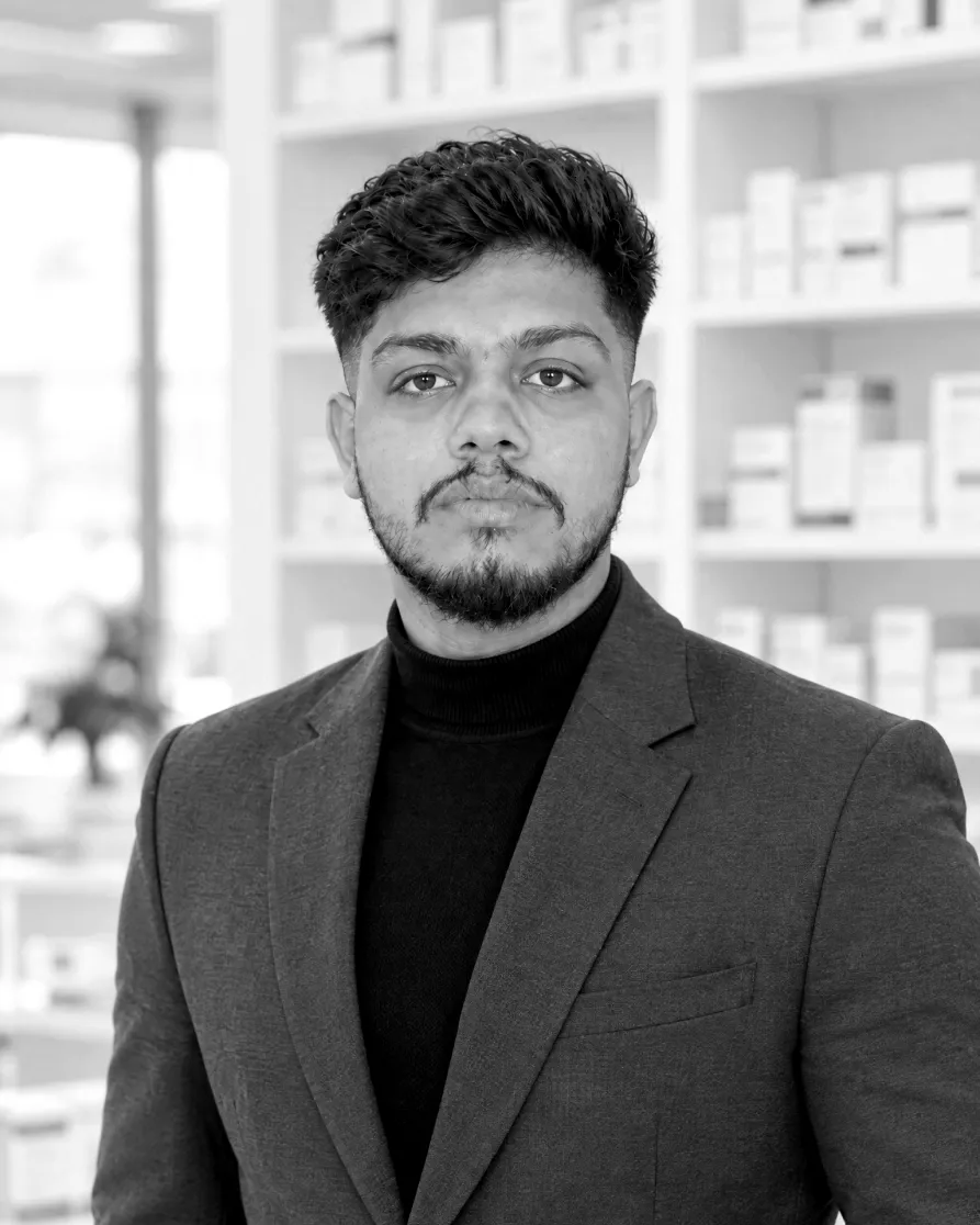 Harish Sharma in a grey blazer in a pharma company office